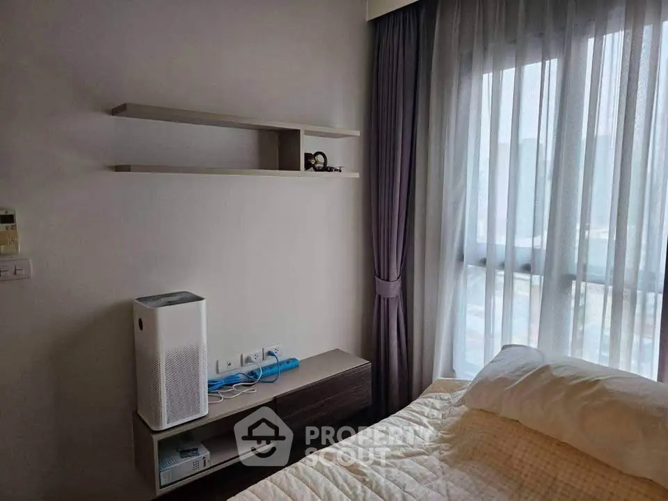 Cozy bedroom with modern air purifier and elegant curtains, perfect for a serene living experience.