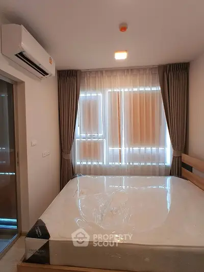 Cozy bedroom with natural light and modern air conditioning unit