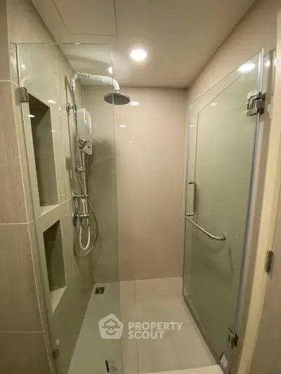 Modern bathroom with glass shower enclosure and sleek fixtures