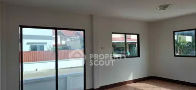 Spacious unfurnished room with large windows and natural light, ideal for customization.