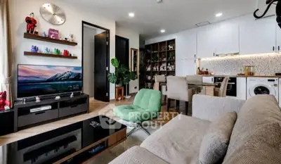 Modern living room with stylish decor, open kitchen, and cozy seating area in a contemporary apartment.