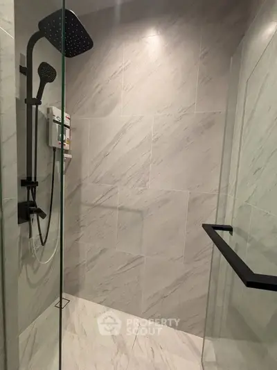 Modern bathroom shower with sleek black fixtures and marble tiles