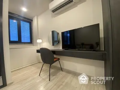 Modern minimalist living room with sleek furnishings, herringbone floor, and ample natural light, perfect for urban living.