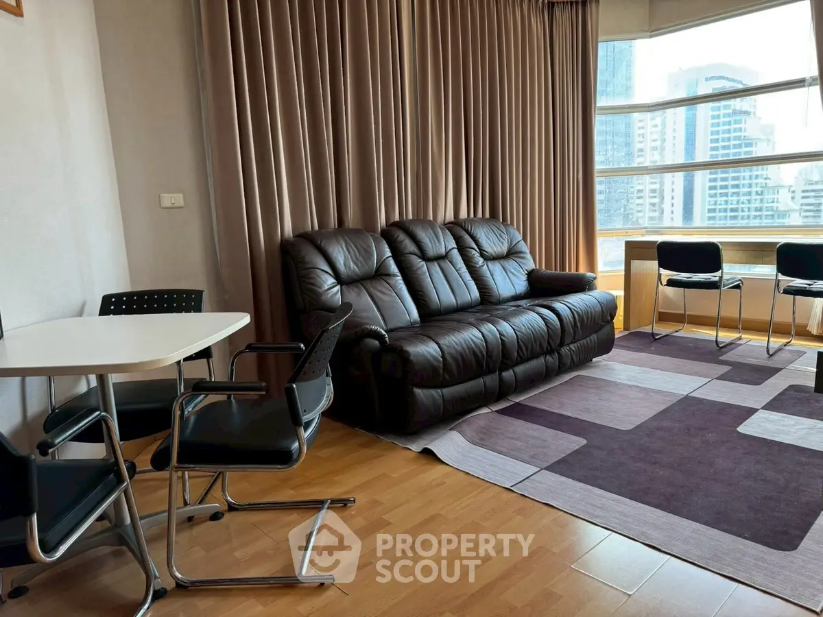 Spacious living room with leather sofa and city view, perfect for urban living.
