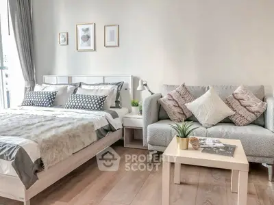 Modern bedroom with cozy bed and stylish sofa in bright interior design.