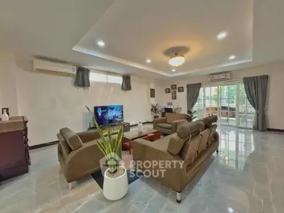 Spacious modern living room with elegant decor and ample natural light.