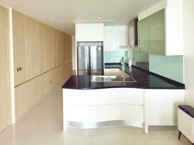 Modern kitchen with sleek design, featuring a large island and stainless steel appliances.
