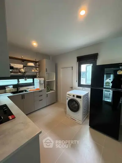 Modern kitchen with sleek appliances and ample storage space