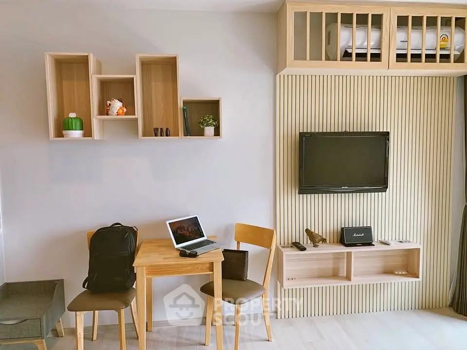 Modern living room with stylish wooden furniture and wall-mounted TV, perfect for cozy urban living.