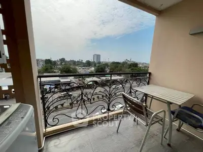Charming balcony with city view, perfect for relaxation and outdoor dining.