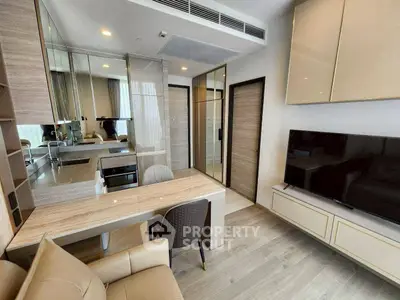 Modern living room with sleek furniture and built-in TV unit, featuring a stylish open layout.