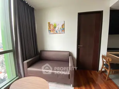 Cozy living room with modern sofa and city view, perfect for urban living.