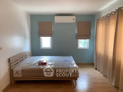 Spacious bedroom with natural light and modern decor