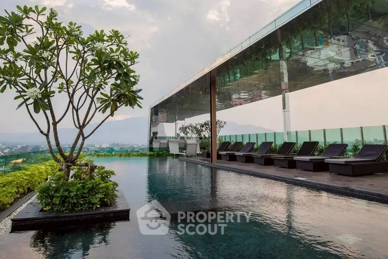 Luxurious rooftop infinity pool with stunning panoramic views and modern lounge chairs.