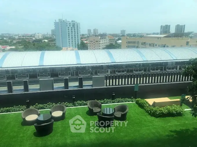 Stunning rooftop garden with modern seating and cityscape views.