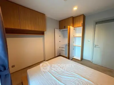 Spacious bedroom with built-in wooden wardrobes and cozy lighting