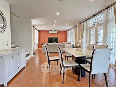Spacious open-plan living and dining area with elegant furnishings and natural light.