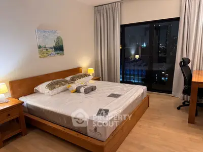 Spacious bedroom with city view, wooden furniture, and modern decor in a luxury apartment.