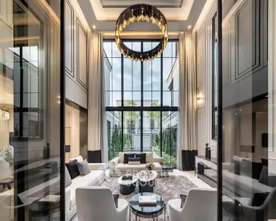 Luxurious modern living room with high ceilings and elegant chandelier