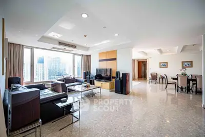 Spacious modern living room with city view, elegant decor, and ample natural light.