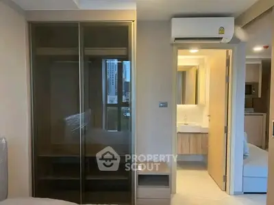 Modern apartment interior with sleek wardrobe and bathroom view