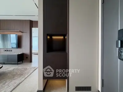 Modern living room with sleek design and open layout, featuring a wall-mounted TV and stylish decor.