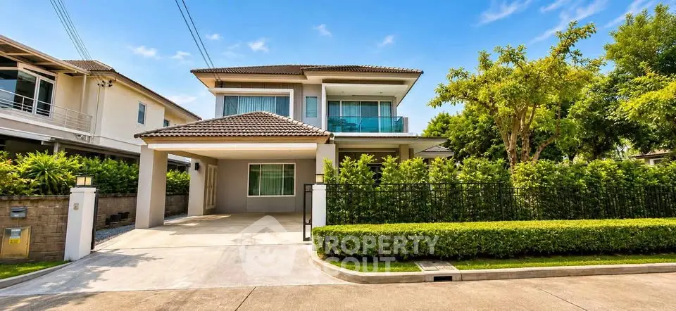 Stunning two-story house with lush garden and spacious driveway in a serene neighborhood.