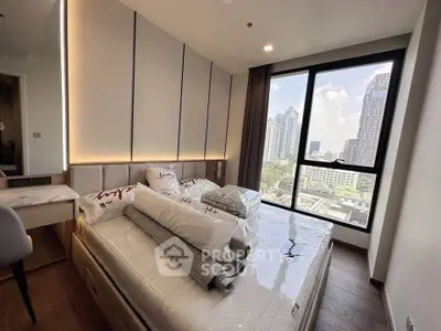 Modern bedroom with city view, featuring large window and stylish decor in a high-rise apartment.