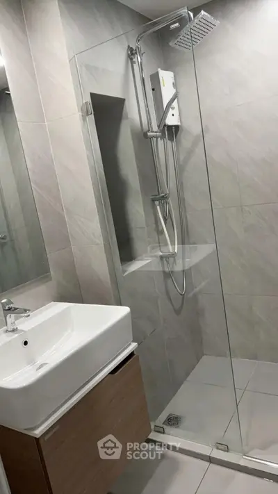 Modern bathroom with glass shower and sleek sink design