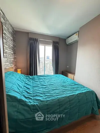 Cozy bedroom with city view, featuring a comfortable bed and modern decor.