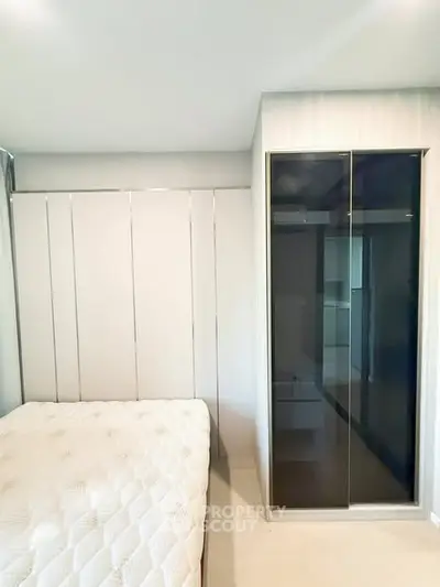 Modern bedroom with sleek wardrobe and comfortable bed in a stylish apartment.