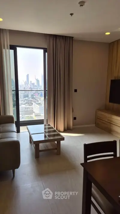 Modern living room with city view, stylish furniture, and natural light.