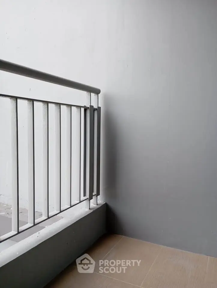 Minimalist balcony with sleek railing and neutral tones, perfect for modern urban living.