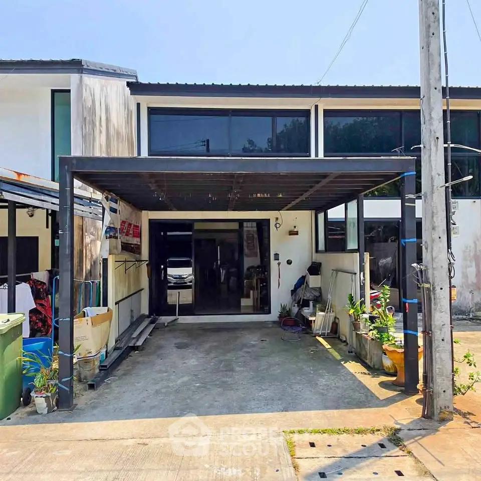 Charming two-story home with covered carport and modern facade, perfect for family living.