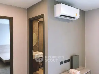Modern apartment interior with air conditioning and bathroom view
