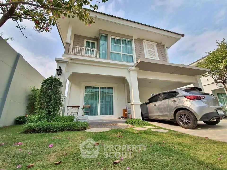 Charming two-story house with a lush garden and carport in a serene neighborhood.