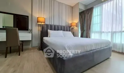 Luxurious bedroom with elegant decor and large windows for natural light.