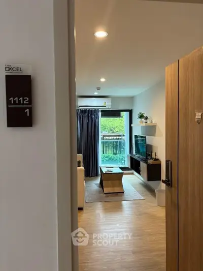 Modern living room with natural light and balcony view in stylish apartment.