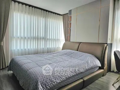 Modern bedroom with stylish decor and large windows for natural light