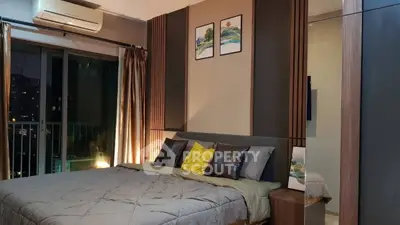 Luxurious bedroom with modern decor and city view, featuring stylish bedding and elegant lighting.