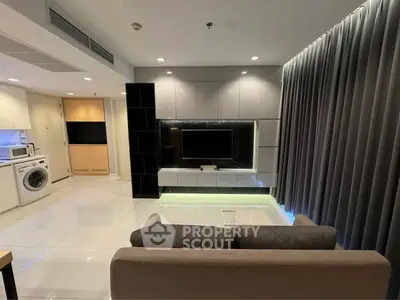 Modern living room with sleek design and integrated appliances, perfect for urban living.