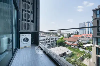 Modern balcony with washing machine and city view, perfect for urban living.
