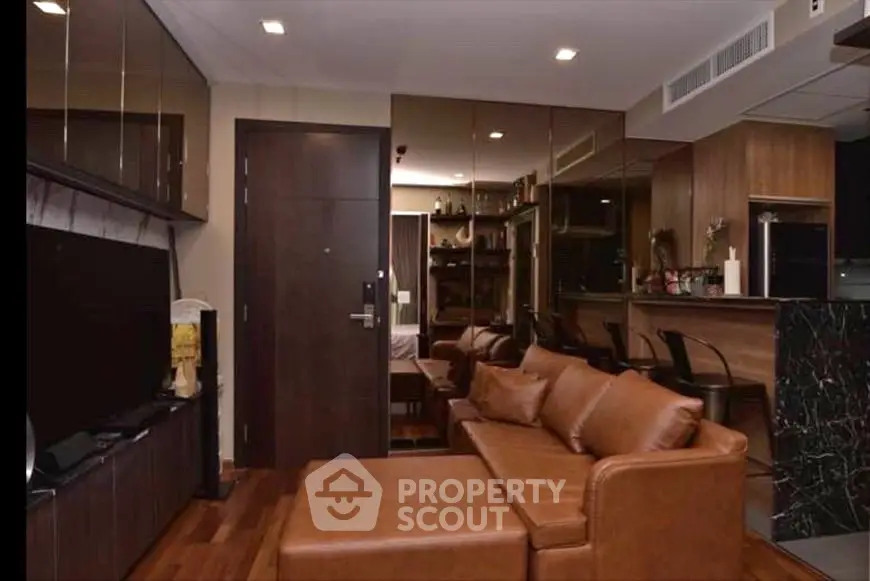Luxurious living room with modern leather sofa and sleek kitchen bar