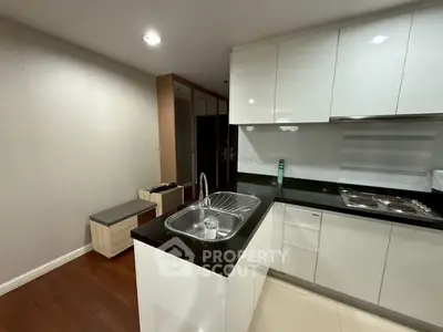 Modern kitchen with sleek cabinetry and built-in appliances in a stylish apartment.