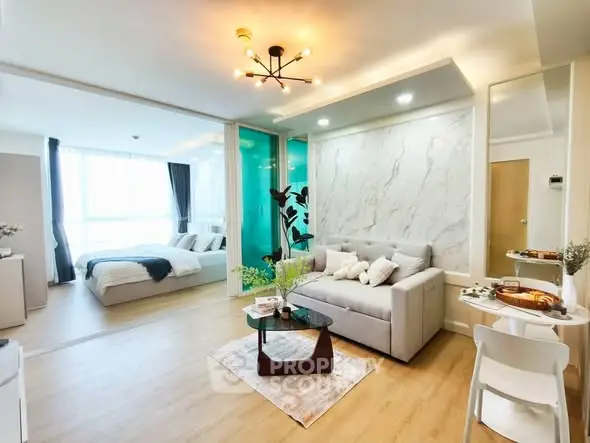 Modern open-plan living room with stylish decor and cozy bedroom area