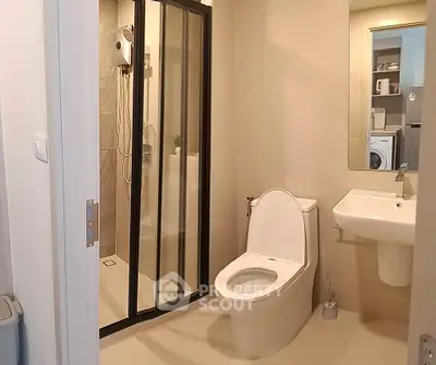 Modern bathroom with shower and washing machine in a stylish apartment.