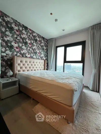 Luxurious bedroom with floral accent wall and city view, featuring elegant bed and plush rug.