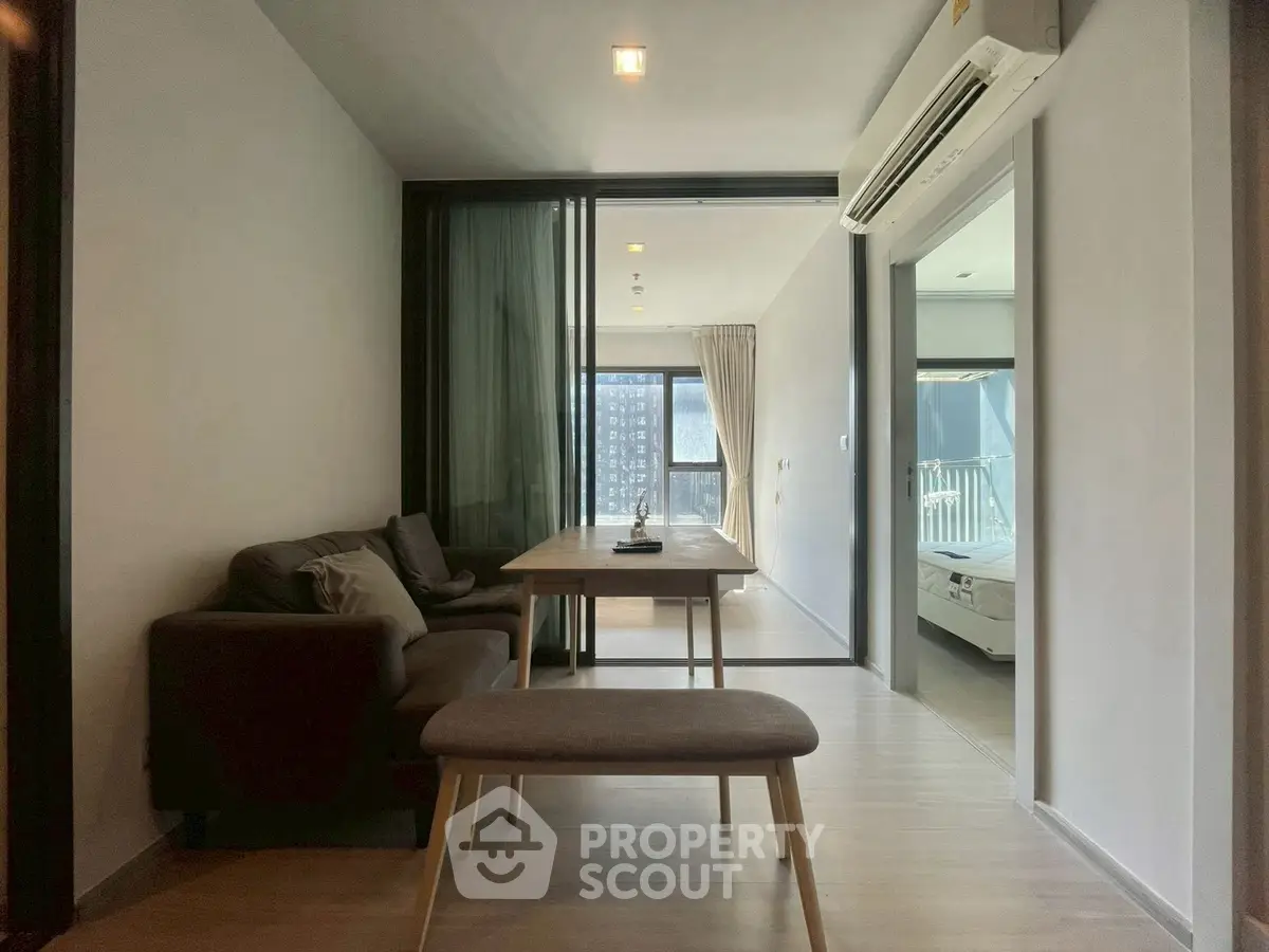 Modern living room with sleek furniture and natural light in a contemporary apartment.