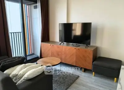 Modern living room with sleek TV setup and balcony view