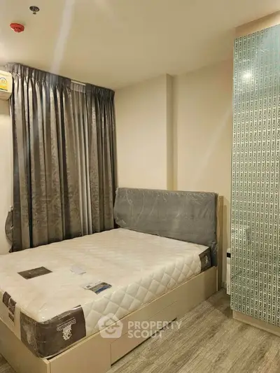 Modern bedroom with stylish decor and natural light, featuring a comfortable bed and elegant curtains.